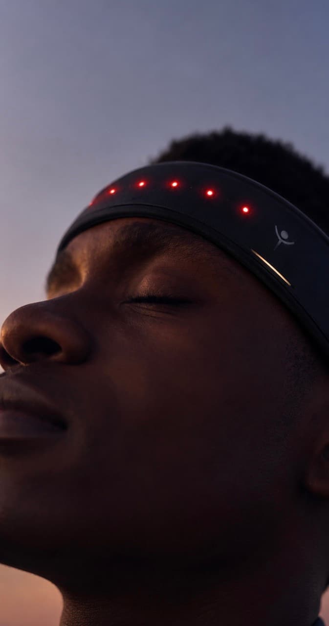 A person wearing the YourLight Band at dusk, eyes closed